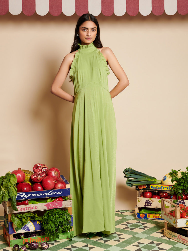 Sister Jane Watercress Maxi Dress in green has a halter neck design and ruffled edges. Perfect for a romantic garden party or a sunlit stroll by the water's edge. 